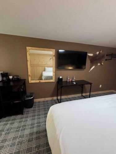 a hotel room with a bed and a mirror at Suite 102 in Lusk