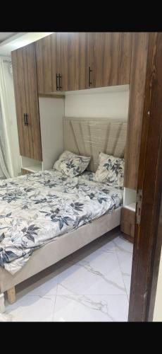a bedroom with a large bed with wooden cabinets at Kelibia in Kelibia