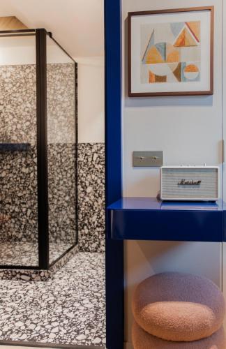 a blue table with a stool in a room at Hotel Leev Miromesnil & Spa in Paris