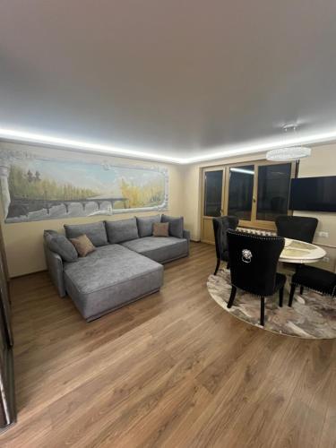 a living room with a couch and a table at Ritos Namai in Druskininkai