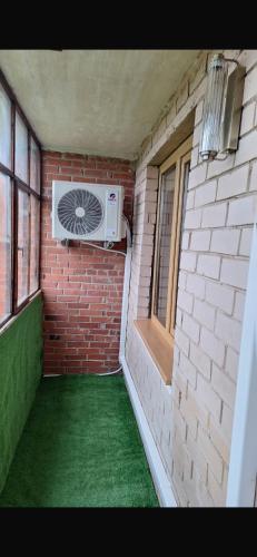 a room with a brick wall with a air conditioner at Ritos Namai in Druskininkai
