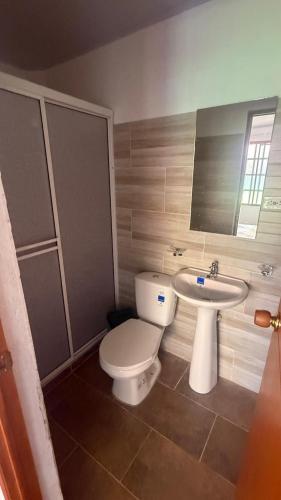 a bathroom with a toilet and a sink at Finca Las Marias A&M in Restrepo