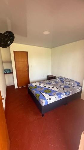 a bedroom with a bed in a room at Finca Las Marias A&M in Restrepo