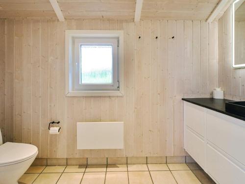 a bathroom with a toilet and a window at 7 person holiday home in Græsted-By Traum in Græsted