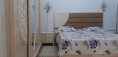 a bedroom with two beds and a mirror at Belle vue in Aïn Draham