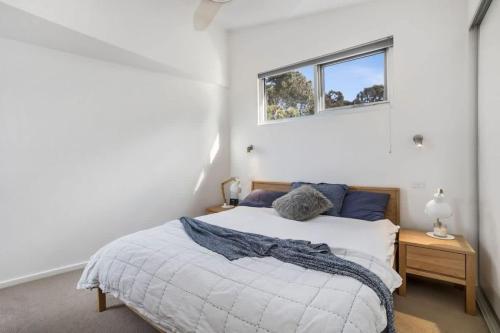 a bedroom with a bed and a window at Coastal Tree Top Views in Aireys Inlet