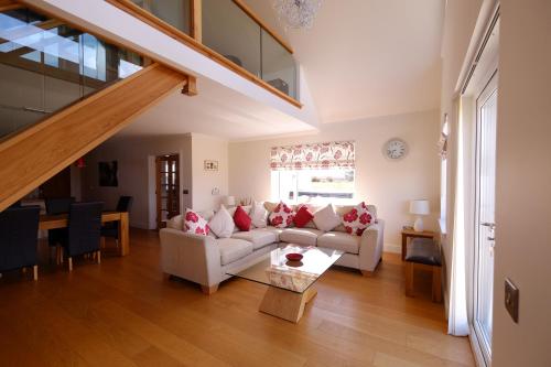 a living room with a couch and a table at Brae Cottage in Dunvegan