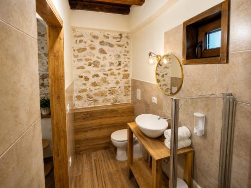 a bathroom with a toilet and a sink and a mirror at Casa Runcis in Cavasso Nuovo