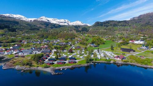 an aerial view of a resort on a lake with mountains at Sauda Fjord Camping in Saudasjøen