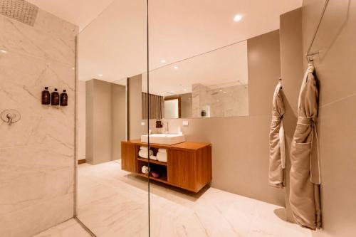 a bathroom with a shower and a sink and a mirror at Hotel San Felipe in Panama City