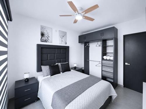 a bedroom with a bed and a ceiling fan at Nice AptPoolBeach ClubParkingGymACBarraVieja in Barra Vieja
