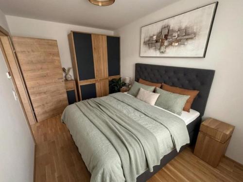 a bedroom with a large bed in a room at Murleben Top 05 in Stadl an der Mur