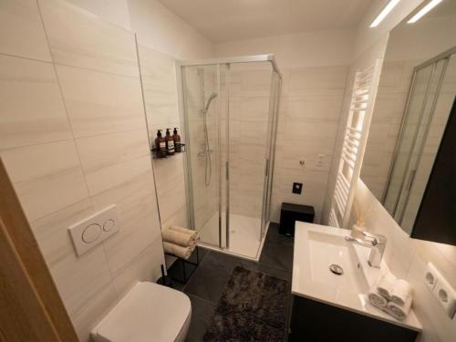 a white bathroom with a shower and a sink at Murleben Top 05 in Stadl an der Mur