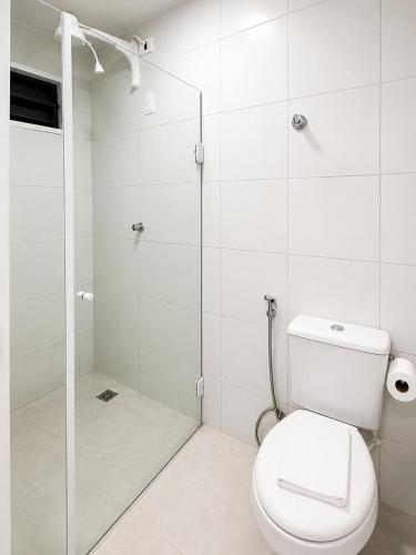 a bathroom with a toilet and a glass shower at Hotel Campina Center in Campina Grande