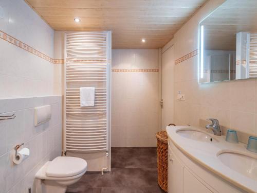 a bathroom with a toilet and a sink and a shower at De Brouwersdam in Ouddorp
