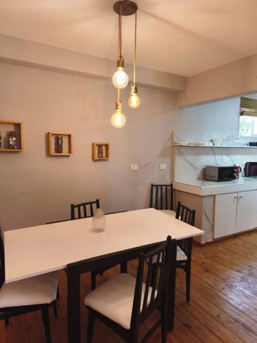 a kitchen and dining room with a table and chairs at Dpto Plaza Colon in Azul