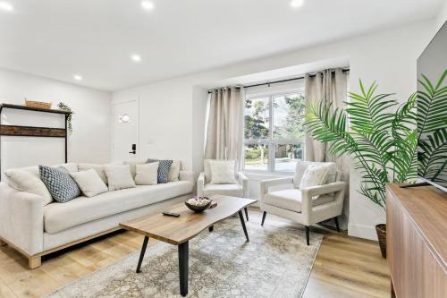 a living room with a couch and a table at Modern 3BR Home, Minutes to Lake & Port Credit in Mississauga