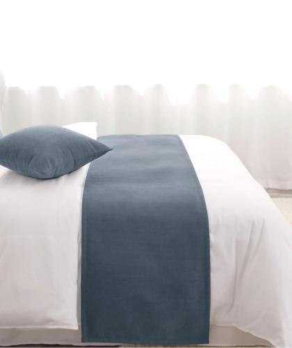a white and blue bed with a pillow on it at Hotel IL MULINO - Colazione a Buffet e Parcheggio Privato in Casalgrande