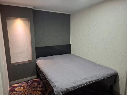 a small room with a small bed in the corner at emplus in Batumi