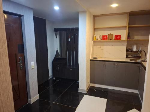 a room with a kitchen with a sink and a counter at emplus in Batumi