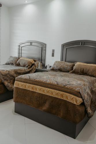 two beds sitting next to each other in a room at Hotel sierra palace in Cuauhtémoc
