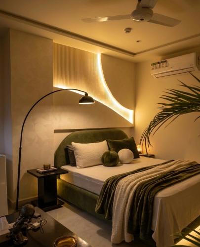 a bedroom with a bed with a light on it at Daró - Self Check-in - 1 BR Apartment - Gulberg - MM Alam - Pool in Lahore