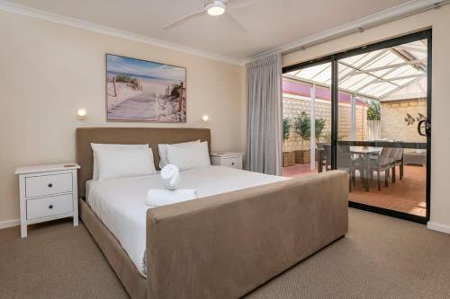 a bedroom with a large bed and a couch at Clearwater - Cosy Comforts Steps from the Beach in Dunsborough