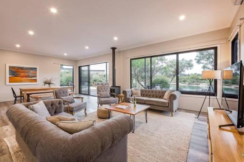 a large living room with a large couch and chairs at Bonnie - Lakeside Relaxation surrounded by Wineries in Wilyabrup