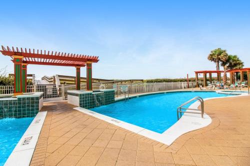 a swimming pool with a gazebo next to a swimming pool at Spacious Gulf Front Condo with Private WD and Shared Pool in Navarre