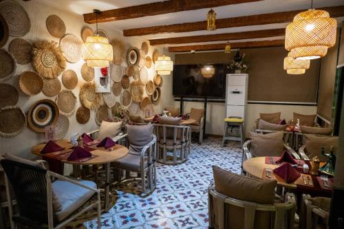 a restaurant with tables and chairs in a room at Le Pacha Pyramids Hotel in Cairo