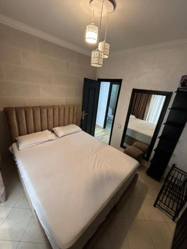 a bedroom with a large white bed in a room at Man Wee Apprt in Tangier