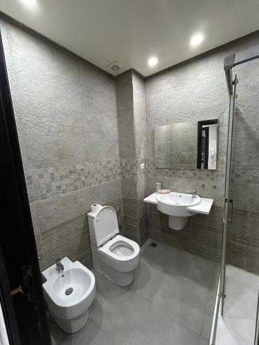 a bathroom with a toilet and a sink at Man Wee Apprt in Tangier