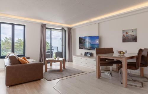 a living room with a table and a dining room at Princess in Binz