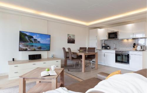 a living room with a table and a kitchen at Princess in Binz