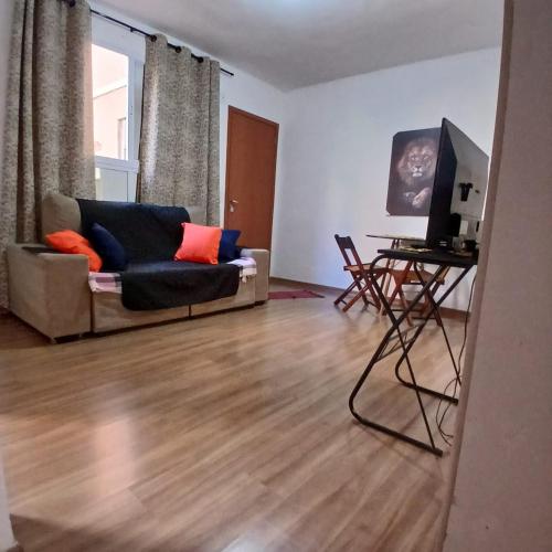 a living room with a couch and a table at Apartamento Harmonia! in Uberaba