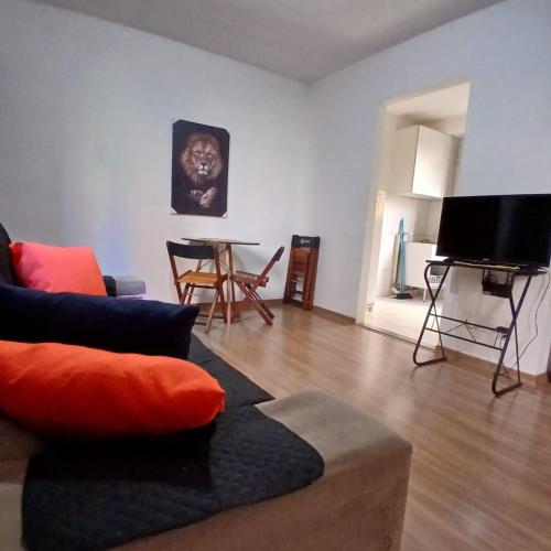 a living room with a couch and a table at Apartamento Harmonia! in Uberaba