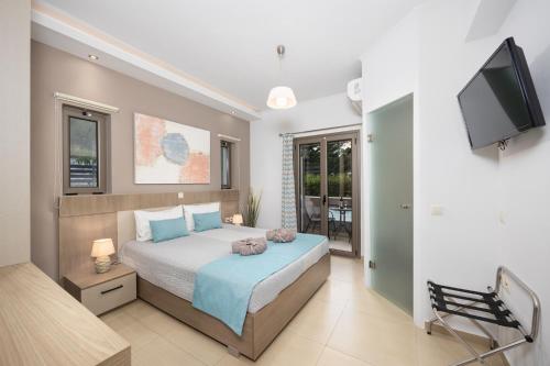 a bedroom with a bed and a flat screen tv at Villa Vatia 2 in Tragaki