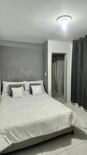 a large white bed in a room with at Apartamentos con aire acondicionado SAN LUIS in San Luis