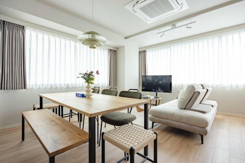 a living room with a dining room table and a couch at SoMA Kagurazaka in Tokyo