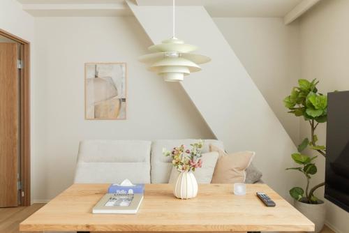 a dining room table with a vase of flowers at SoMA Kagurazaka in Tokyo
