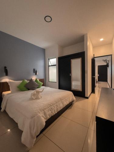 a bedroom with a large bed with a clock on the wall at La Casona in Fortuna