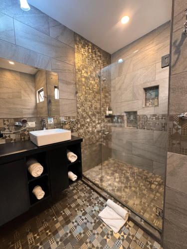 a bathroom with a glass shower and a sink at La Casona in Fortuna