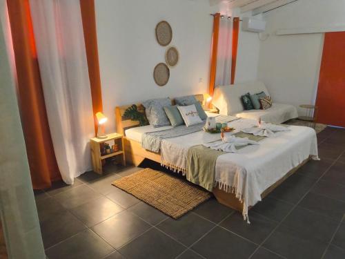 a bedroom with a bed and a couch in it at Terakota lodge in Deshaies