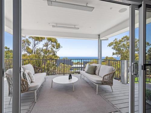 an outdoor patio with couches and a table at Eagle Heights - Elevated Oasis with Pool & Sea Views in Dunsborough