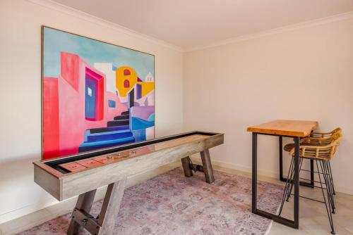 a painting on a wall in a room with a table at Torretta by the Bay in Dunsborough