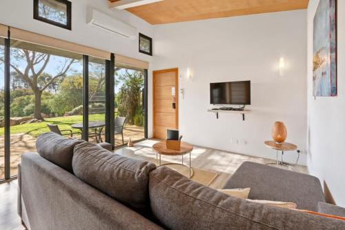 a living room with a couch and a tv at Petra Olive 4 in Yallingup