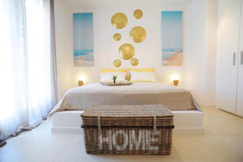 a bedroom with a bed with a basket in front of it at Lidia Villa in Panormos Mykonos