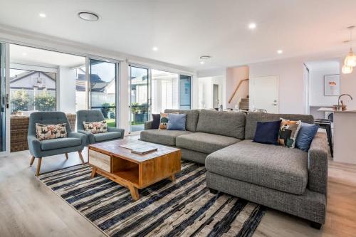 a living room with a couch and two chairs and a table at Fernweh - A Generous Hamptons-style Beachside Escape in Geographe