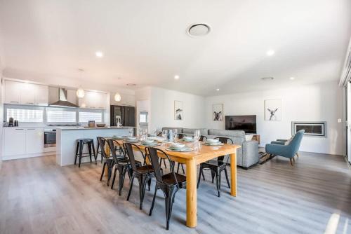 a dining room and kitchen with a table and chairs at Fernweh - A Generous Hamptons-style Beachside Escape in Geographe