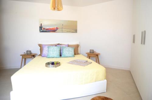 a bedroom with a white bed with a bowl on it at Lidia Villa in Panormos Mykonos